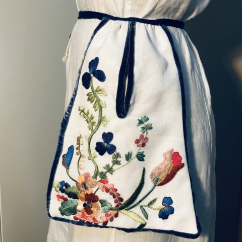 colorful florals embroidered with silk threads on an 18th century white linen tie-waist pocket