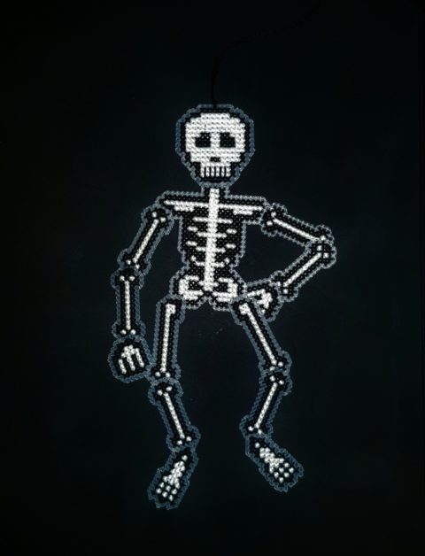 Cross stitch skeleton jointed hanging decoration posed with hand on hip