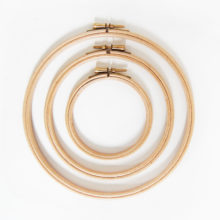 Wood embroidery hoops arranged concentrically on a white background