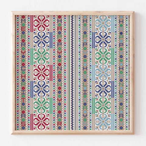 A Palestinian needlework of geometric shapes stitched in repeating columns between messages of holiday greetings