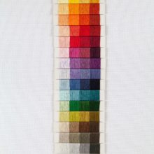 A rainbow of floss swatches arranged in a 4 by 16 grid