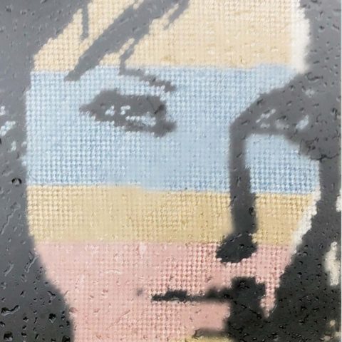 cross-stitch of a woman's face overlaid with large pastel stripes
