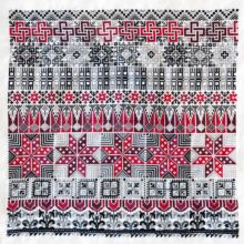 Rows of traditional Palestinian tatreez cross-stitch motifs stitched in red and gray on white fabric