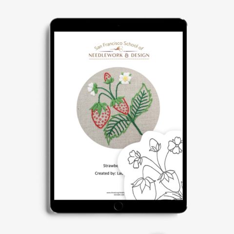 A small spray of strawberries with flowers and leaves embroidered on natural linen displayed in a tablet with a bit of the pattern drawing layered on top