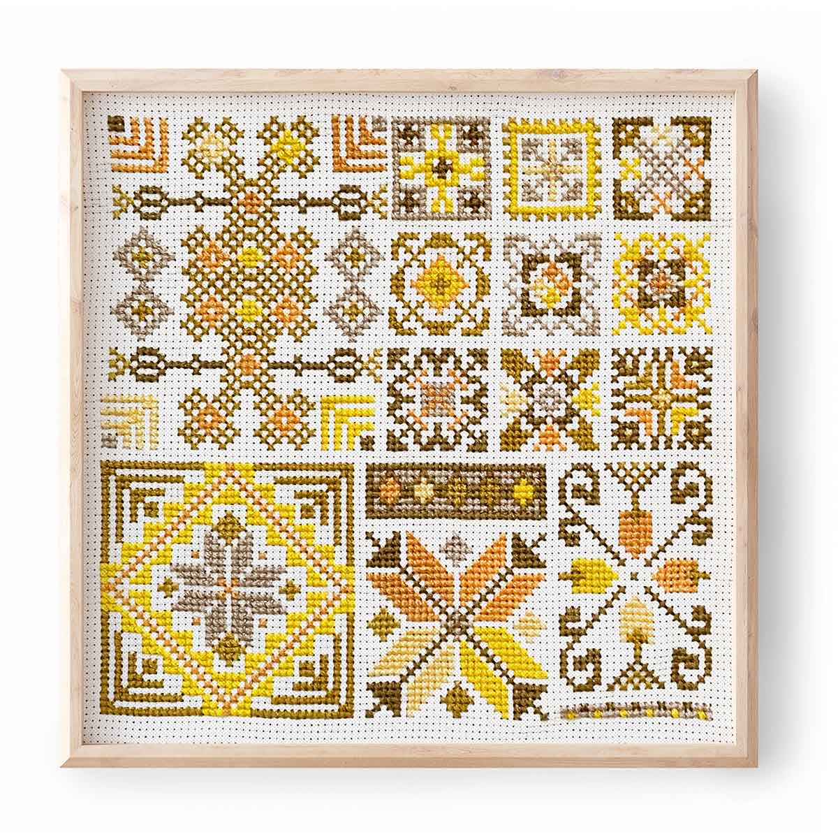 Sundance tatreez pattern by DecoElian stitched in various golds in frame