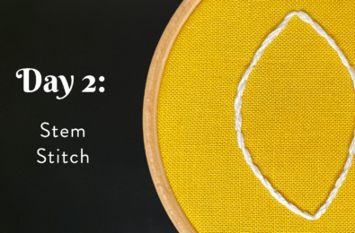 An embroidery hoop with a leaf stitched in white on yellow fabric next to the words, "Day 2: Stem Stitch."