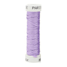 a spool of light purple silk thread on a white background