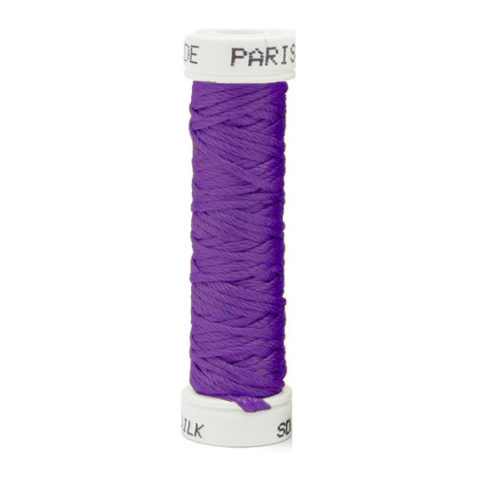 a spool of purple silk thread on a white background