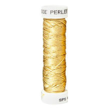a spool of golden yellow silk thread on a white background