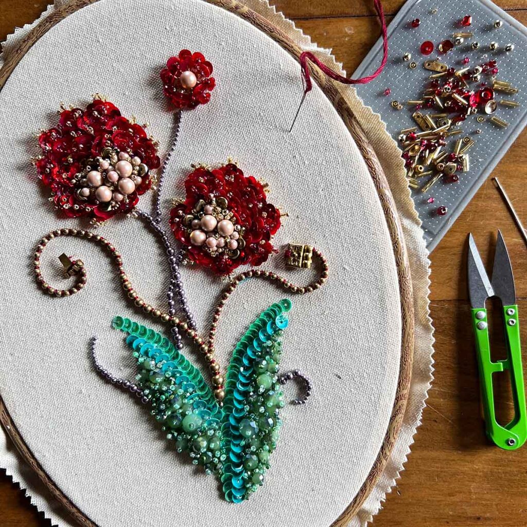 bead embroidery of a spray of red flowers by jake wobig