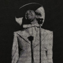 cab calloway spotlit behind a microphone stitched in grayscale on black fabric