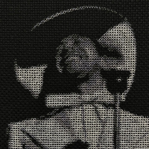 closeup of cab calloway spotlit behind a microphone stitched in grayscale on black fabric