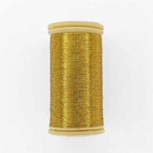 spool of sajou fil a gant au chonois waxed cotton gloving thread 120 gold metallic