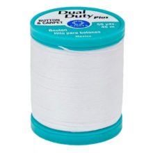 white thread on a turquoise plastic spool