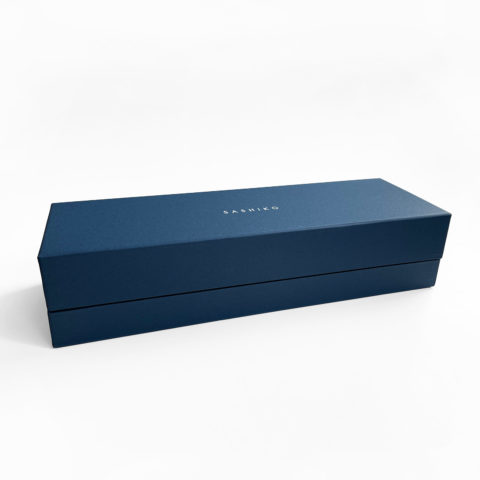 A dark blue paper gift box with the word "sashiko" stamped on top in white