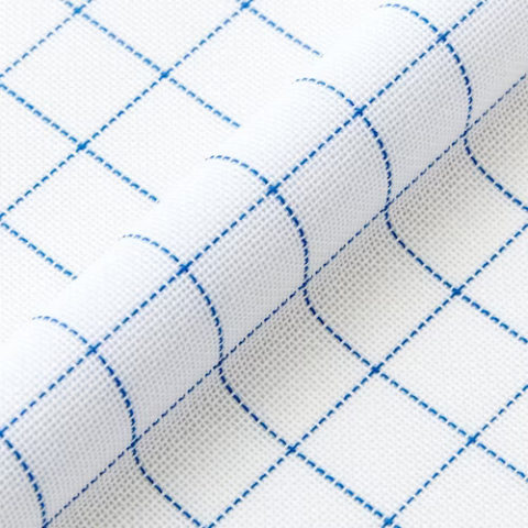 close up of white woven fabric with a thin blue grid printed on it
