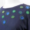 a navy tshirt embroidered with circular designs around the yoke in blue and green
