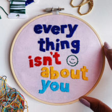 embroidery pattern composed of text that reads “Everything isn’t about you” with a smiley face graphic accenting the text