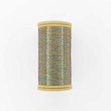 a spool of sajou fil a gant au chonois waxed cotton gloving thread 182 Harlequin