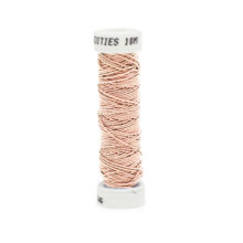 A spool of filament fine silk gimp 6030 pale pink on a white background