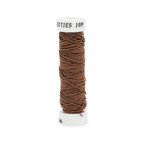 A spool of filament fine silk gimp 6268 Flaxseede brown on a white background