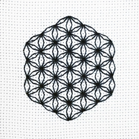 flower of life mystical circle design stitched using blackwork embroidery on white aida canvas.