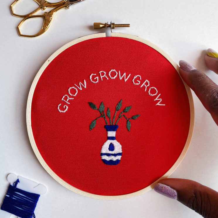 embroidery pattern composed of text that reads “Grow, grow, grow” and a potted plant design accenting the text