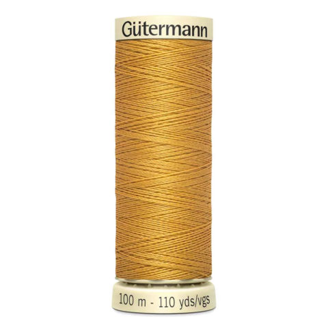 spool of gutermann cotton thread in gold