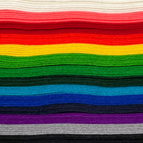 A rainbow stack of felt sheets viewed from the side