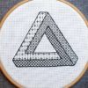 impossible penrose triangle blackwork embroidery on white fabric in a wood hoop