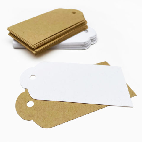 kraft and white recycled paper gift tags stacked on a white surface
