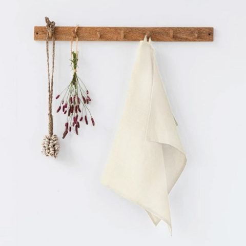 ivory tea towel hangin on a wooden wall peg
