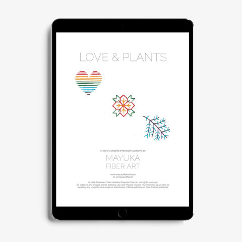 A Tablet showing the cover page for mini winter-themed paper embroidery patterns including a rainbow heart, a branch, and a poinsettia