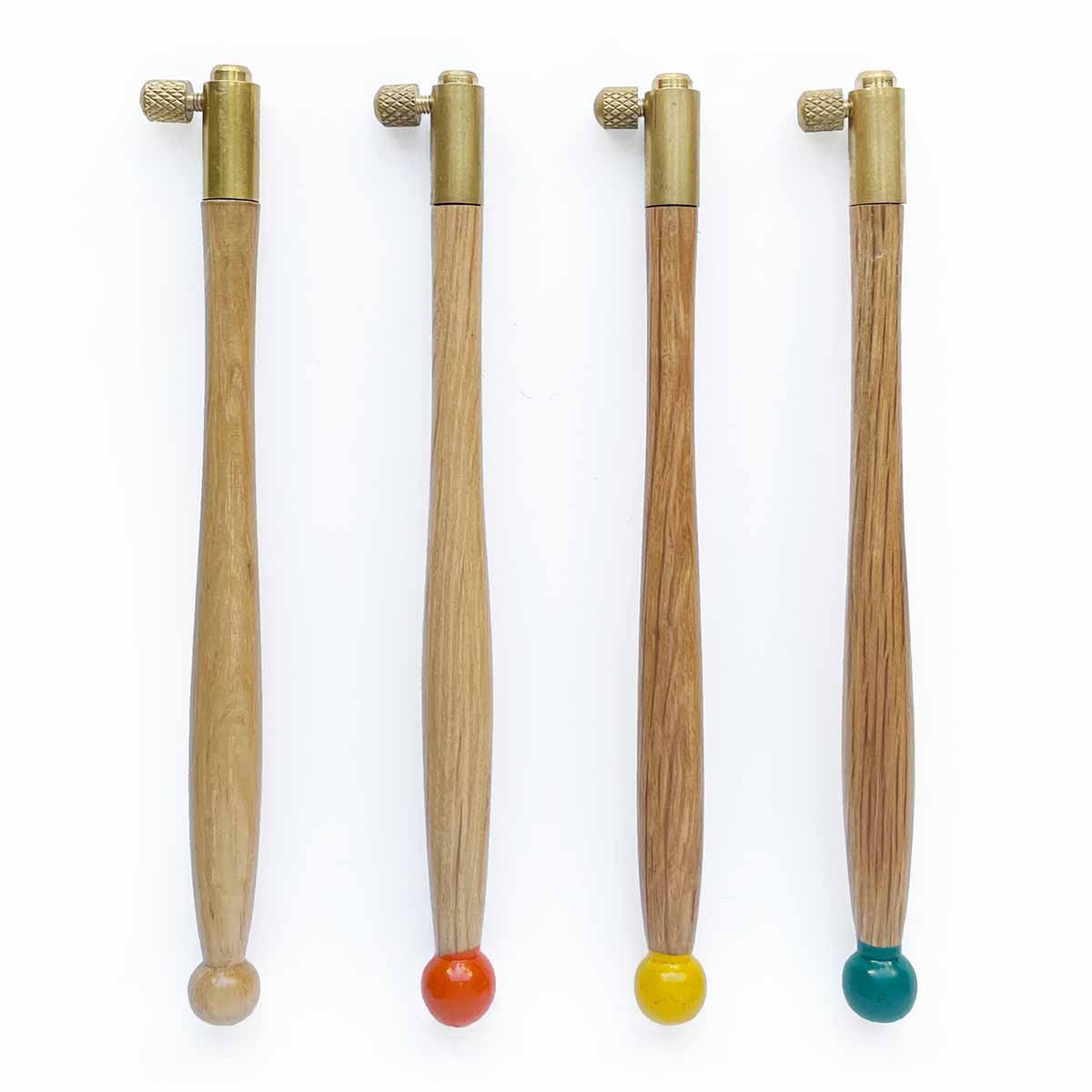 Four turned wood tambour handles with different colored carved balls on the ends