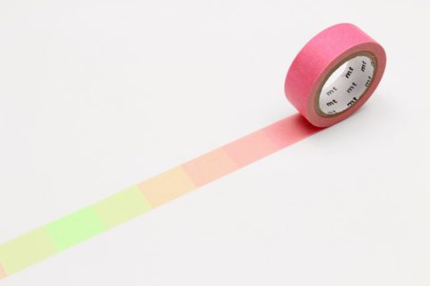 A roll of mt washi tape unrolled to show a warm color gradient