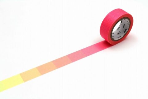 A roll of mt washi tape unrolled to show a warm color gradient