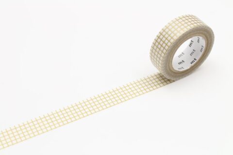 A roll of partially unrolled washi tape with a gold grid pattern