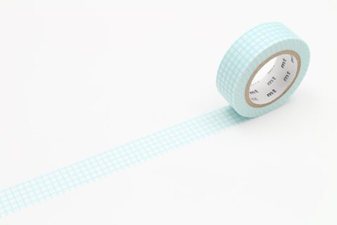 A roll of partially unrolled washi tape with a mint blue grid pattern