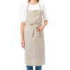 a light-skinned woman's torso wearing a white shirt and a natural linen bib apron