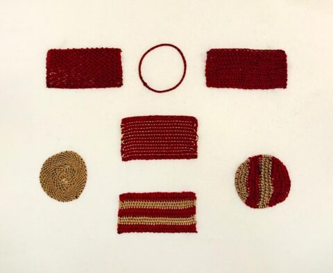 circle and rectangle needlelace swatches stitched in burgundy and gold on a white background
