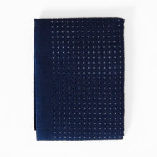 olympus dotted cotton sashiko fabric in navy blue, folded into a small packet on a white background