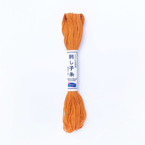 A skein of olympus sashiko cotton thread in carrot orange