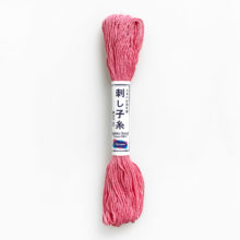 A skein of olympus sashiko cotton thread in rose pink