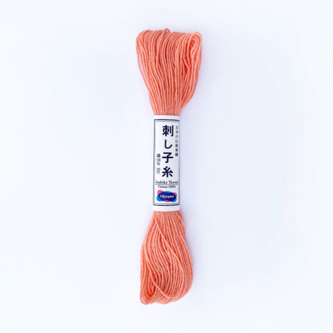 A skein of olympus sashiko cotton thread in peach