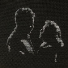 orson welles and loretta young dimly lit stitched in grayscale on black fabric