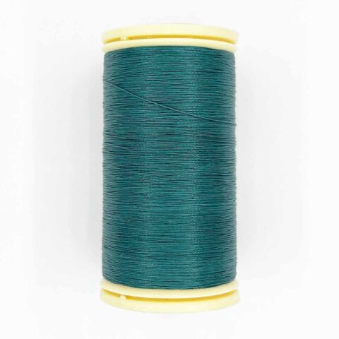 spool of sajou fil a gant au chonois waxed cotton gloving thread 879 emerald