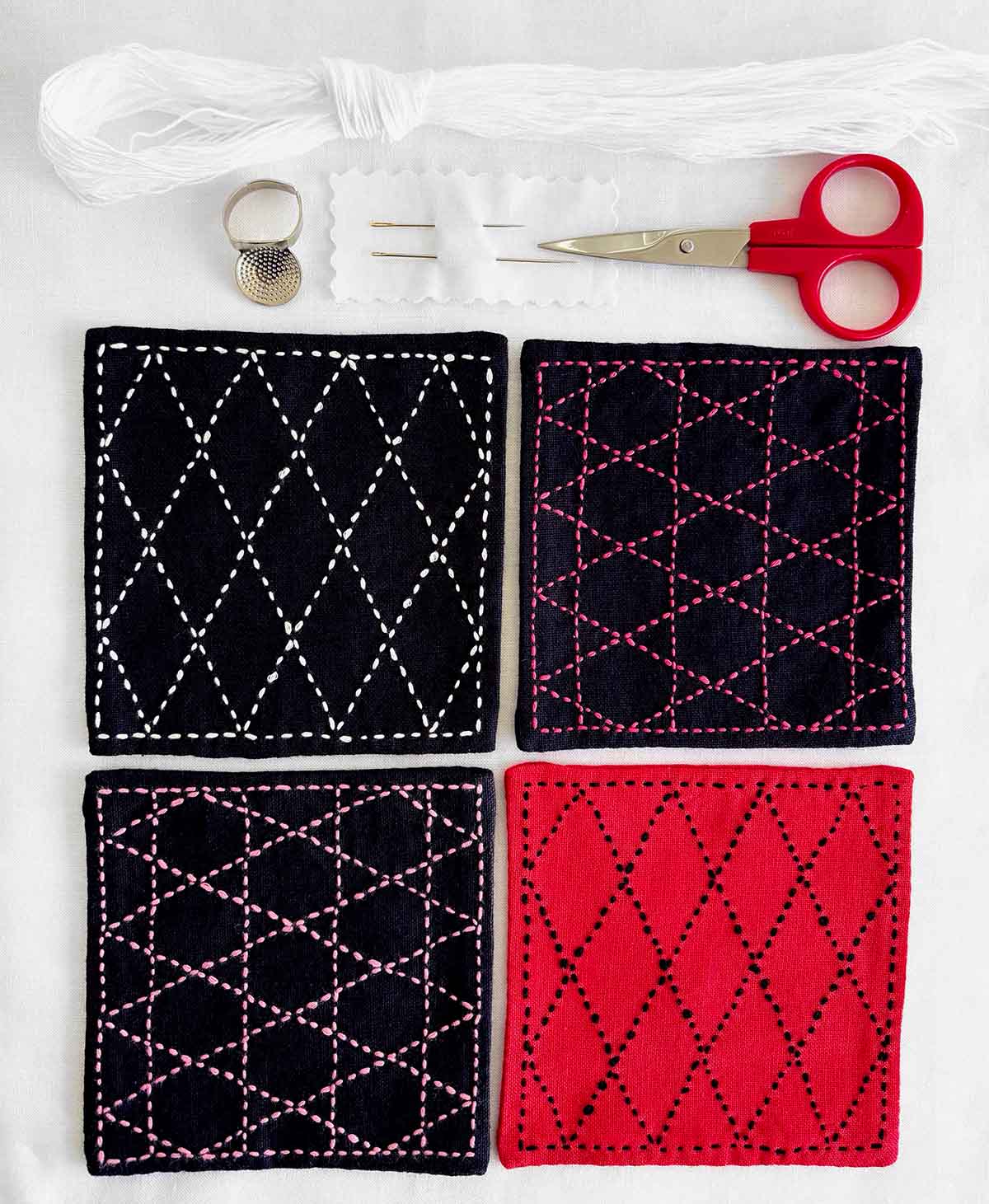 a set of four sashiko stitched coasters in red and navy with supplies laid out above