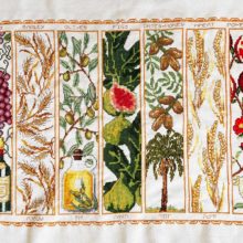 seven species of israeli agriculture (grapes, wheat, olives, figs, dates, barley, pomegranates) cross stitched in vertical panels