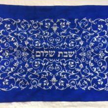 shabbat shalom scrollwork cross stitched in white and silver on a royal blue challah cover