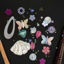 tambour hooks and sequins on chalkboard
